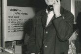 Woman on the phone somewhere outside the conference room. 
(IAEA Archives/Credit: Photo Ellinger)