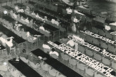 Conference staff is being given instructions, while the big letters for the stage decorations are visible on the table. 
(IAEA Archives/Credit: Photo Ellinger)