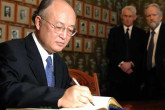 9 December 2005 | Ambassador Yukiya Amano signs the Nobel Peace book under the watchful gaze of earlier Laureates whose portraits hang on the wall.  As Chairman of the IAEA Board of Governors, the Japanese Ambassador is representing the Agency for its share of the 2005 prize.