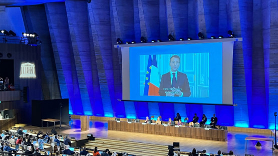 President Emmanuel Macron of France speaks via video recording at the Second Session of the Intergovernmental Negotiating Committee on Plastic Pollution in Paris, France, 29 May 2023. (Photo: P. Bersuder/IAEA)