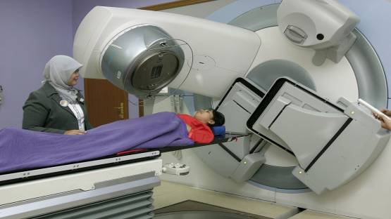 A radiation therapist setting up a patient for treatment on a Linear Accelerator.