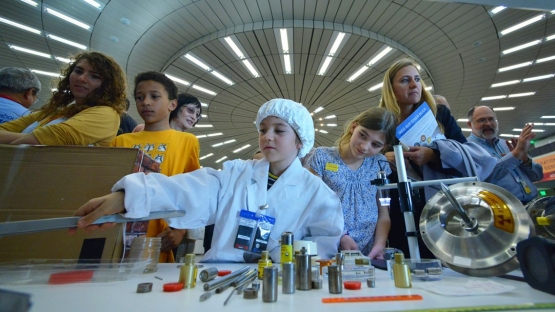 Children handle mock radioactive sources at the Long Night of Research on 22 April 2016, Vienna International Centre, Austria